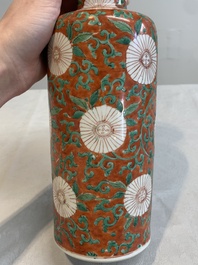 A Chinese famille verte coral-red-ground rouleau vase with flower scrolls, Kangxi