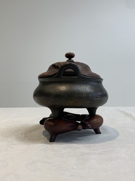 A Chinese bronze tripod censer with wooden cover and stand, Xuande mark, 18/19th C.