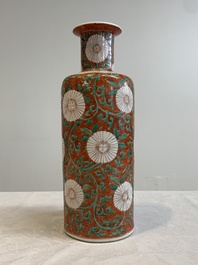 A Chinese famille verte coral-red-ground rouleau vase with flower scrolls, Kangxi
