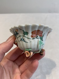 A Chinese famille rose 'rooster' teapot with applied floral design, two cups and a saucer, Yongzheng/Qianlong
