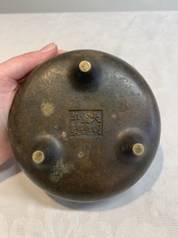 A Chinese bronze tripod censer with wooden cover and stand, Xuande mark, 18/19th C.