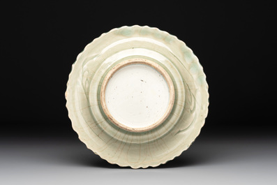 A Chinese blue and white celadon-ground plate with floral design, Ming