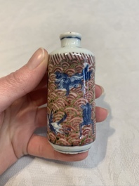 A pair of Chinese blue, white and copper-red 'mythical beasts' and a famille rose 'grasshopper' snuff bottle, Yongzheng and Daoguang mark, 19th C.