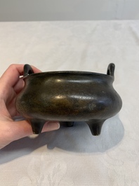 A Chinese bronze tripod censer with wooden cover and stand, Xuande mark, 18/19th C.