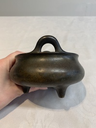 A Chinese bronze tripod censer with wooden cover and stand, Xuande mark, 18/19th C.