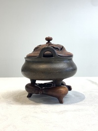 A Chinese bronze tripod censer with wooden cover and stand, Xuande mark, 18/19th C.