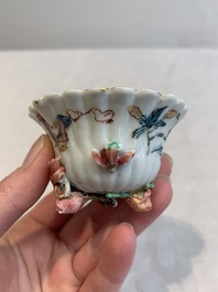 A Chinese famille rose 'rooster' teapot with applied floral design, two cups and a saucer, Yongzheng/Qianlong