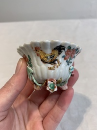 A Chinese famille rose 'rooster' teapot with applied floral design, two cups and a saucer, Yongzheng/Qianlong