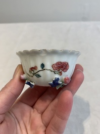 A Chinese famille rose 'rooster' teapot with applied floral design, two cups and a saucer, Yongzheng/Qianlong