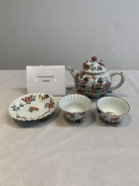 A Chinese famille rose 'rooster' teapot with applied floral design, two cups and a saucer, Yongzheng/Qianlong