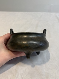 A Chinese bronze tripod censer with wooden cover and stand, Xuande mark, 18/19th C.