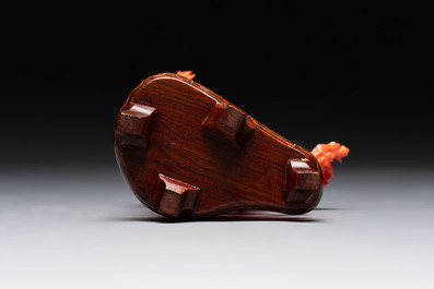 A Chinese red coral figure of a goddess on wooden stand, 19/20th C.