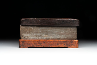 Two Chinese carved bamboo brush pots and an ink stone with wooden cover and stand, signed He Xuanting 何選廷 and Dian Liangbi 典良弼, 19th C.