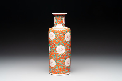 A Chinese famille verte coral-red-ground rouleau vase with flower scrolls, Kangxi
