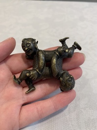 A Chinese bronze scroll weight in shape of two boys, Qing