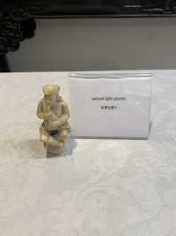 A carved alabaster figure of a seated bagpiper, Low Countries, possibly 17th C.