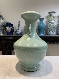 A pair of Chinese celadon-glazed vases with 'anhua' design on wooden stands, Qianlong mark, 19th C.