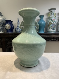 A pair of Chinese celadon-glazed vases with 'anhua' design on wooden stands, Qianlong mark, 19th C.