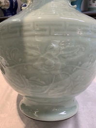 A pair of Chinese celadon-glazed vases with 'anhua' design on wooden stands, Qianlong mark, 19th C.