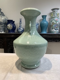 A pair of Chinese celadon-glazed vases with 'anhua' design on wooden stands, Qianlong mark, 19th C.