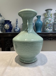 A pair of Chinese celadon-glazed vases with 'anhua' design on wooden stands, Qianlong mark, 19th C.