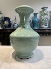 A pair of Chinese celadon-glazed vases with 'anhua' design on wooden stands, Qianlong mark, 19th C.