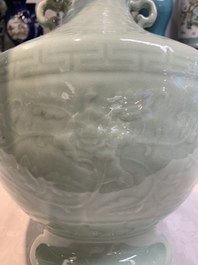 A pair of Chinese celadon-glazed vases with 'anhua' design on wooden stands, Qianlong mark, 19th C.