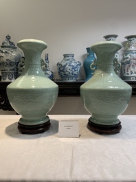 A pair of Chinese celadon-glazed vases with 'anhua' design on wooden stands, Qianlong mark, 19th C.