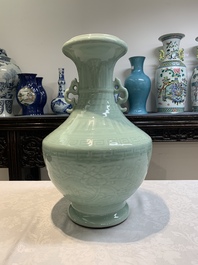 A pair of Chinese celadon-glazed vases with 'anhua' design on wooden stands, Qianlong mark, 19th C.
