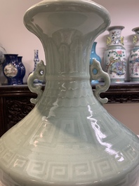 A pair of Chinese celadon-glazed vases with 'anhua' design on wooden stands, Qianlong mark, 19th C.