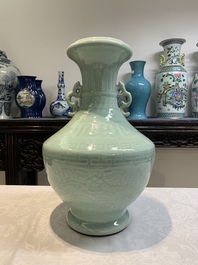 A pair of Chinese celadon-glazed vases with 'anhua' design on wooden stands, Qianlong mark, 19th C.