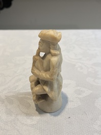 A carved alabaster figure of a seated bagpiper, Low Countries, possibly 17th C.