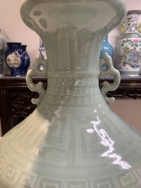A pair of Chinese celadon-glazed vases with 'anhua' design on wooden stands, Qianlong mark, 19th C.