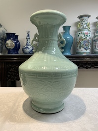 A pair of Chinese celadon-glazed vases with 'anhua' design on wooden stands, Qianlong mark, 19th C.
