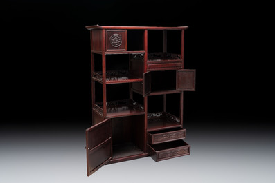 A Chinese carved wooden cabinet with chilong design, 20th C.