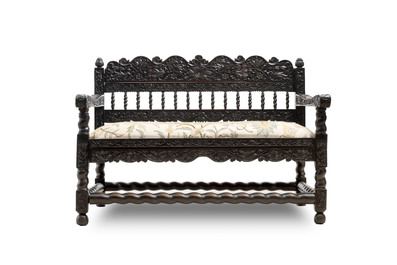 A Dutch colonial carved and ebonized wooden bench, 18th C.