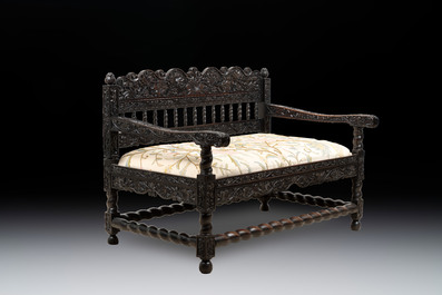 A Dutch colonial carved and ebonized wooden bench, 18th C.