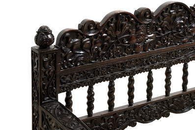 A Dutch colonial carved and ebonized wooden bench, 18th C.