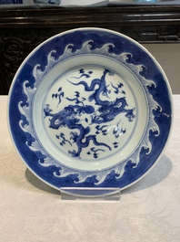 A pair of Chinese blue and white 'dragon' plates and a plate with narrative design, Yuzhen mark, Kangxi/Yongzheng