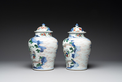 A pair of Chinese wucai vases and covers with court ladies and playing boys, Transitional period