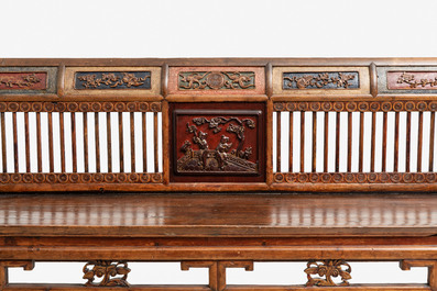 A Chinese carved and lacquered wooden bench, 19th C.