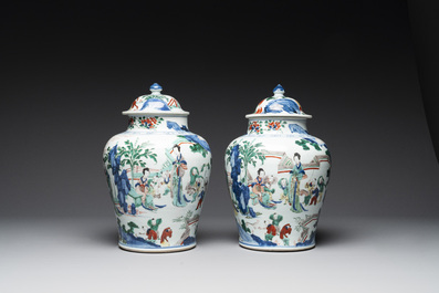 A pair of Chinese wucai vases and covers with court ladies and playing boys, Transitional period
