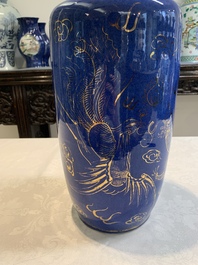 A Chinese gilt-decorated powder-blue 'dragon and phoenix' rouleau vase, 19th C.