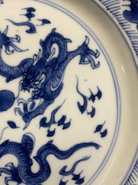 A pair of Chinese blue and white 'dragon' plates and a plate with narrative design, Yuzhen mark, Kangxi/Yongzheng