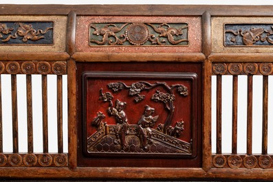 A Chinese carved and lacquered wooden bench, 19th C.
