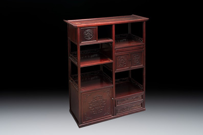 A Chinese carved wooden cabinet with chilong design, 20th C.