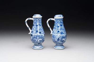 A pair of Chinese blue and white jugs and covers with floral design, Kangxi