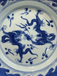 A pair of Chinese blue and white 'dragon' plates and a plate with narrative design, Yuzhen mark, Kangxi/Yongzheng
