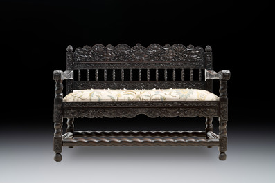 A Dutch colonial carved and ebonized wooden bench, 18th C.