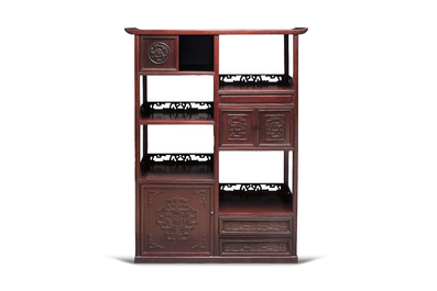 A Chinese carved wooden cabinet with chilong design, 20th C.